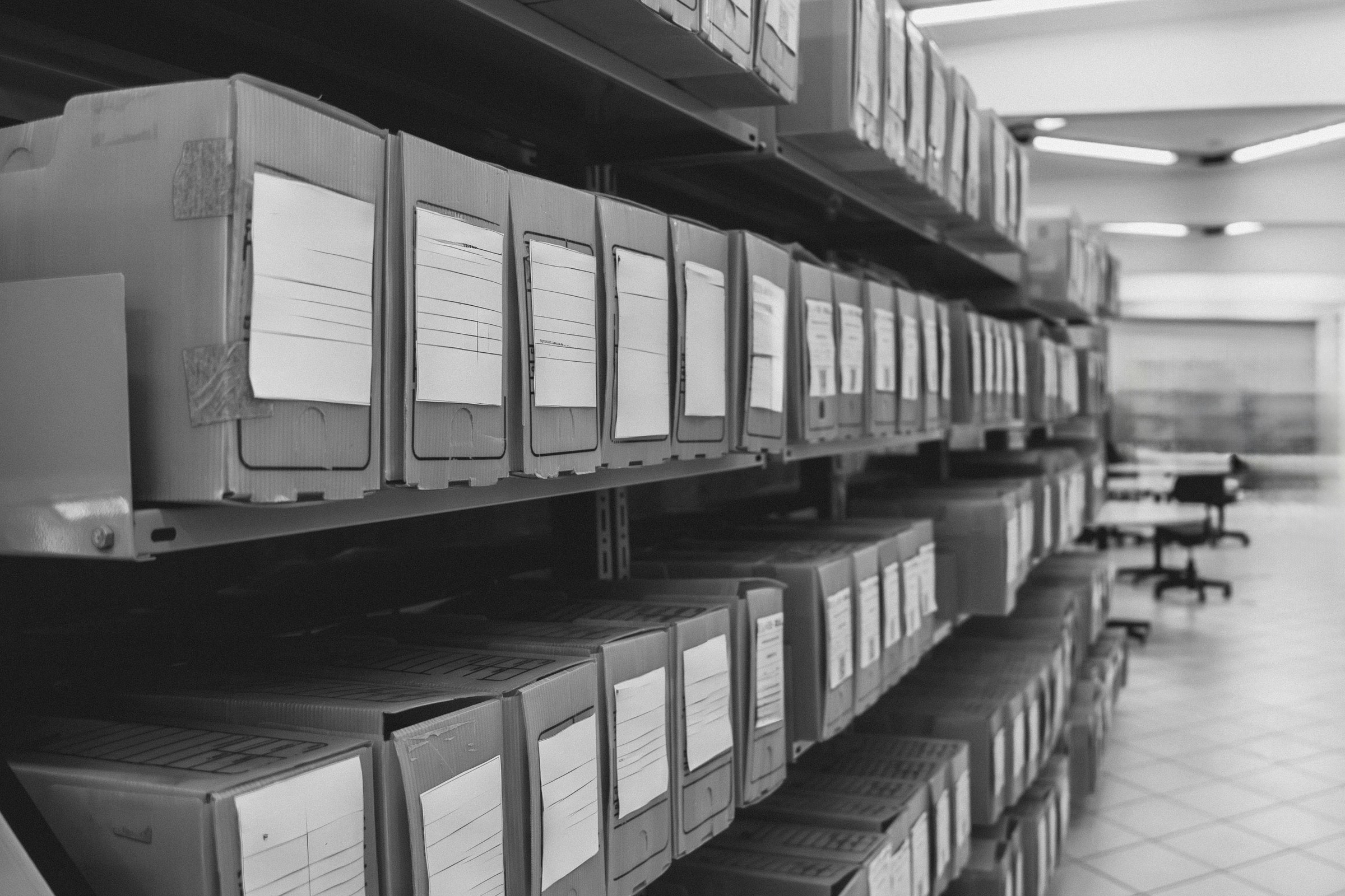 Paper binders representing scattered handover, maintenance and audit evidence.