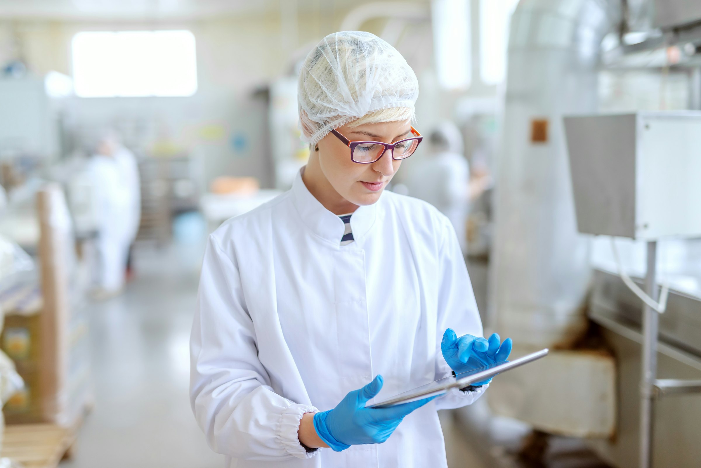 Hospital technician reviewing operational data on a tablet.
